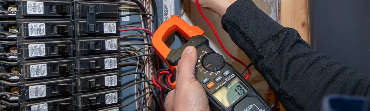 Electrician replacing a residential electrical panel in Leland, NC