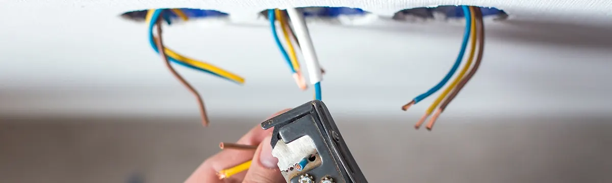 Electrician installing new wiring during a whole-home rewiring in Leland, NC